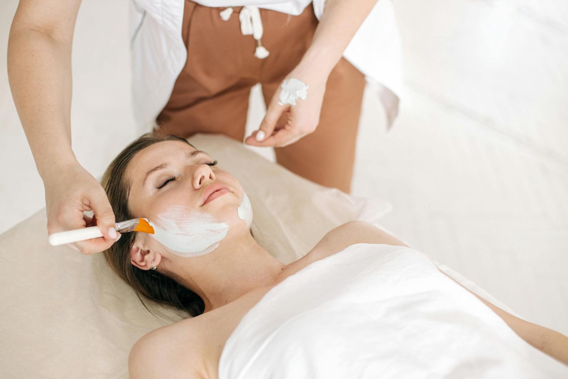 Woman receiving a rejuvenating facial treatment